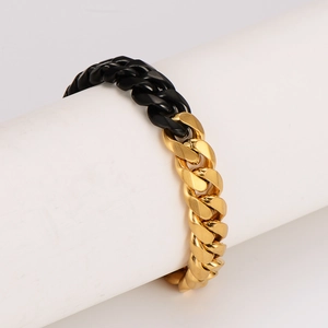 Men's two-tone Cuban link bracelet featuring half polished gold and half matte black finish