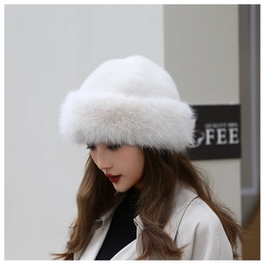 Close-up of thick white faux fur winter beanie hat showing fluffy plush texture details