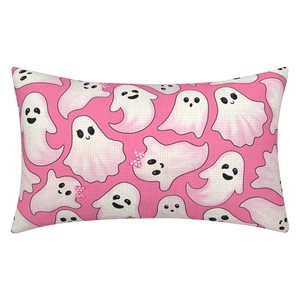 Detailed texture of pink Halloween pillowcase featuring cute white cartoon ghosts