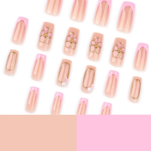 Pink French press-on nails with 3D floral accents and gold embossed metal details