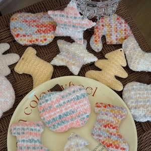 Handmade knitted Christmas ornaments including stars and trees in colorful textured yarn