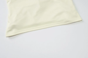 Close-up of the double-needle stitching on the off-white mesh fabric hem of the long skirt