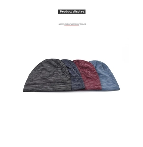 Detail view of four textured knit beanies in gray, navy, red, and light blue colors
