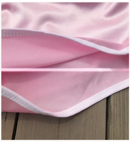 Macro detail of pink satin fabric with breathable mesh lining and white edge stitching