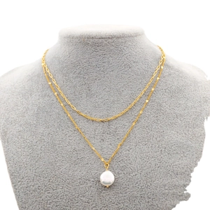 Double-layered gold chain necklace with paperclip links and a white pearl pendant