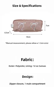 Pink fabric pencil case with white bow embroidery and dimensions 19x7x6.5cm