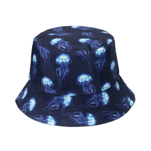 Detail of navy blue bucket hat featuring a luminous jellyfish print and ocean theme pattern