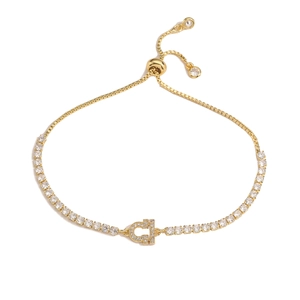 Macro shot of gold-plated adjustable bracelet with sparkling zircon buckle and slide clasp