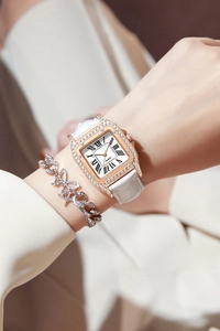 Close-up of rose gold square quartz watch with rhinestones and butterfly bracelet