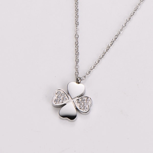 Detailed view of silver four-leaf clover pendant with sparkling rhinestones on fine chain