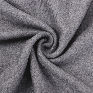 Macro shot showing the thick grey wool fabric texture and soft felt fibers of the scarf