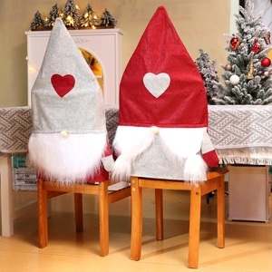Detail of red and grey gnome chair covers with long beards for Christmas home decor