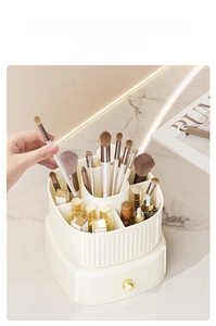 Macro view of rotating makeup brush holder with compartments and gold handle drawer