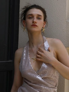 Detail of 18K gold-plated starfish pendant necklace and earrings set on a model