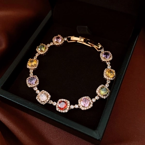Detailed close-up of 18k gold-plated bracelet with multi-colored square-cut gemstones