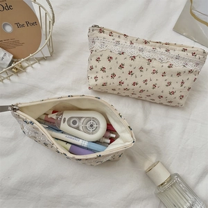 Close-up of floral canvas storage pouches with lace trim and stationary details
