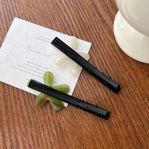 Acetate floral hair clips in cream and green, set on a minimalist poetic card background