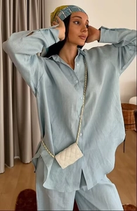 Close-up of light blue linen-textured lounge set featuring a button-down shirt and pants