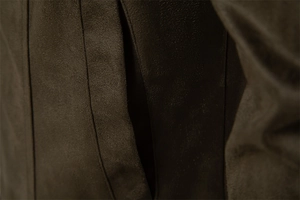 Macro shot of vertical stitching and side pocket on dark suede jacket fabric