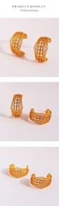 Detailed macro view of French vintage lace hollow C-shaped hoop earrings with zircons