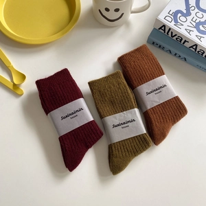 Three pairs of vintage wool slouch socks in burgundy, army green, and caramel colors