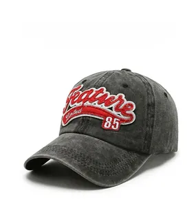 Close-up of vintage charcoal grey denim baseball cap with detailed red 3D embroidery