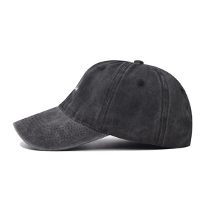 Close-up of vintage washed cotton baseball cap featuring detailed embroidery and stitching