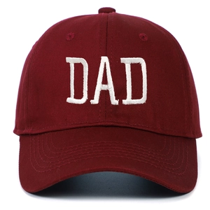 Close-up of white DAD embroidery on a premium burgundy cotton twill baseball cap