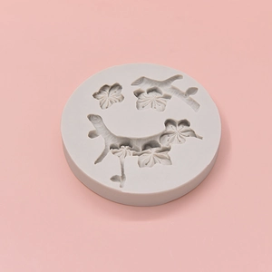 Round gray silicone mold for cherry blossom fondant with floral branch patterns