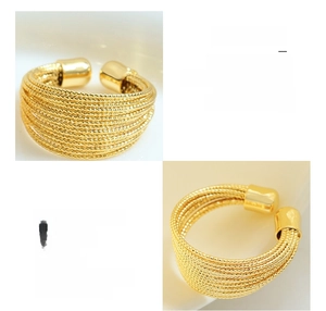 Macro detail of multilayered 18K gold plated surgical titanium steel open ring band