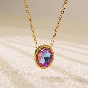 Macro shot of circular faceted iridescent crystal pendant with golden necklace chain