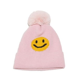 Detailed view of pink knitted beanie with a yellow smiley patch and top pompom