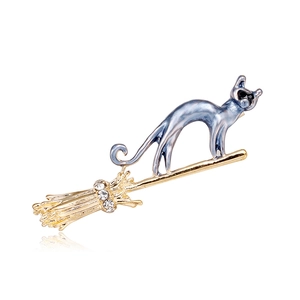Creative blue-grey cat and golden broom brooch with sparkling rhinestone accents