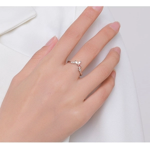 Close-up of elegant V-shaped S925 silver ring with red and white zircons on model