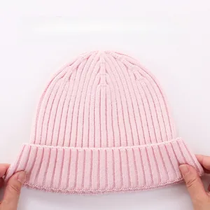 Detail showing the high elasticity and ribbed knit texture of the pink baby winter hat