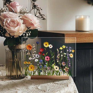 Detailed view of floral acrylic art piece with a natural wood base on lace tablecloth