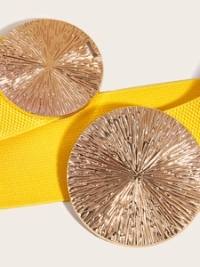 Close-up of bright yellow elastic waist belt with large textured gold circular buckles