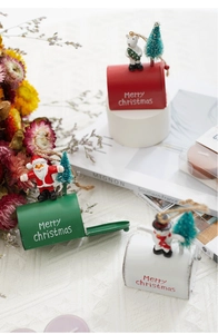 Detailed view of festive mini metal mailboxes with Christmas figurines and tree decorations