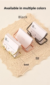 Close-up of wire metal business card holders in black, gold, and rose gold finishes