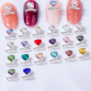 Macro view of heart-shaped nail rhinestones in various colors with alloy settings