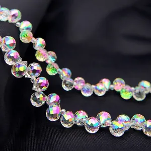 Macro shot of faceted AB crystal teardrop beads with iridescent rainbow colorful coating