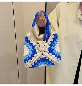 Detail of crochet sunflower tote bag with pearl clasp and braided blue handle