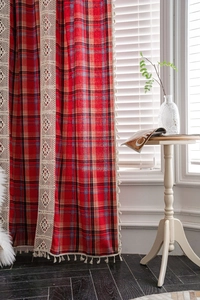 Detail of red Christmas plaid curtain with beige lace trim and elegant tassel fringe