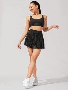 Detailed view of the black high-waisted pleated mini skirt with adjustable drawstring bow