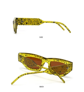 Side and back view of cat-eye sunglasses with yellow ink pattern and metal rivets
