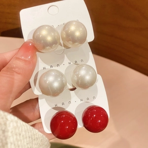 Detailed set of round pearl stud earrings in champagne, cream white and vibrant red