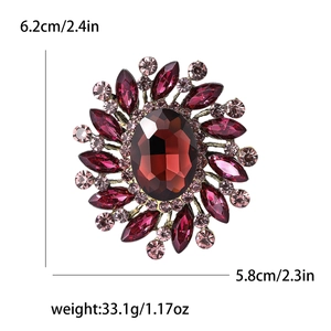 Macro detail of vintage floral glass brooch with red rhinestones and 6.2cm height scale