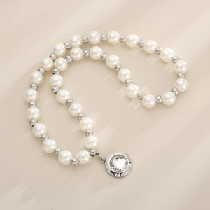 Detail of pearl necklace with silver spacer beads and a sparkling crystal pendant