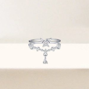 Macro detail of silver butterfly ring with dangling zircon stones and double layered band