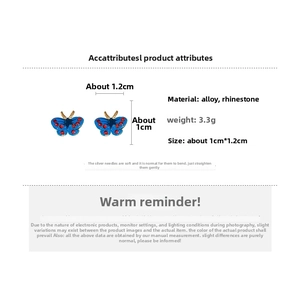 Detailed view of butterfly earrings with blue enamel, red rhinestones and 1.2cm size